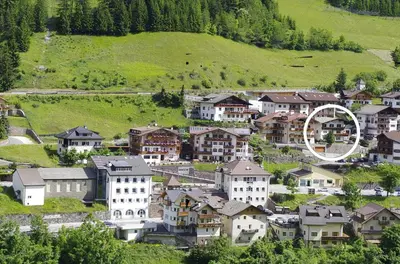 an aerial view of a village with houses and a circle at Garni Le Chalet in Santa Cristina in Val Gardena