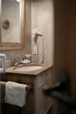 a bathroom with a sink and a mirror at Apartments Isgla in Selva di Val Gardena