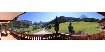 a view of a mountain range from a building at Garni Martlhof in Selva di Val Gardena