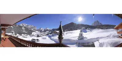 a view of a snow covered mountain from a ski lodge at Garni Martlhof in Selva di Val Gardena