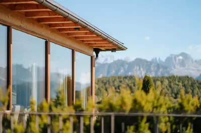 a view of a mountain from a house with windows at Hotel am Hang in Soprabolzano