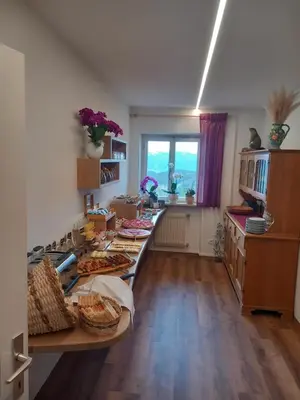 a kitchen with a long table with food on it at Schartnerhof in Collalbo