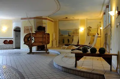 a living room with a table and chairs at Hotel Wildschütz in San Leonardo in Passiria
