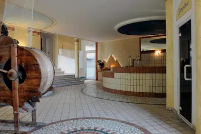 a room with a large wooden drum in a building at Hotel Wildschütz in San Leonardo in Passiria