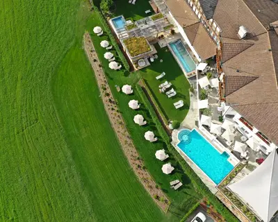 an overhead view of a farm with a pool and animals at Hotel Schönblick in Rodengo
