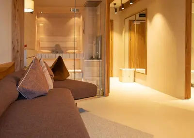 a living room with a couch and a mirror at Hotel Schönblick in Rodengo