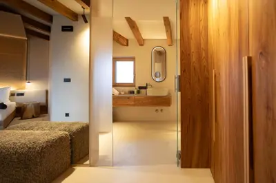 a bedroom with a bed and a sink and a mirror at Hotel Schönblick in Rodengo