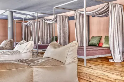 a room with two beds and a room with a mirror at Hotel Pustertalerhof in Chienes