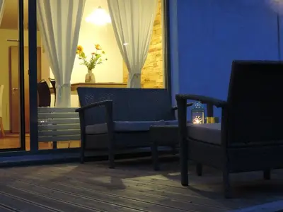 a blue room with two chairs and a window at B&B Casa Vanzetta in Ziano di Fiemme