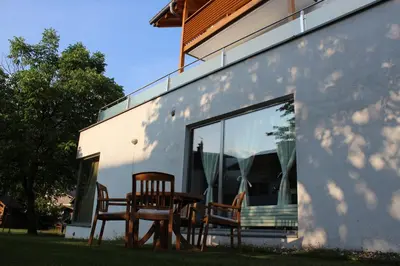 two chairs and a table in front of a window at B&B Casa Vanzetta in Ziano di Fiemme