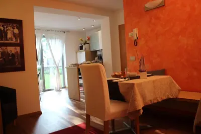 a kitchen and dining room with a table and chairs at B&B Casa Vanzetta in Ziano di Fiemme