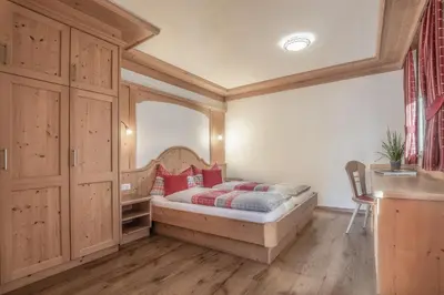 a bedroom with a bed with a large mirror at Apartments Rit in La Valle