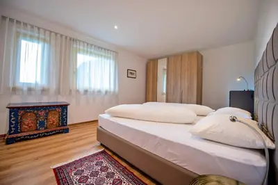 a bedroom with two beds and a fireplace at Apartment Villa Valeria in Selva di Val Gardena