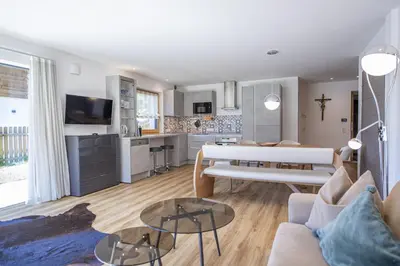 a living room with a couch and a table at Apartment Villa Valeria in Selva di Val Gardena