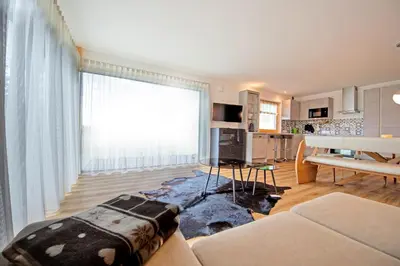a living room with a couch and a table at Apartment Villa Valeria in Selva di Val Gardena