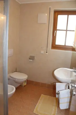 a bathroom with a toilet and a sink and a tub at Beikircherhof in San Lorenzo di Sebato