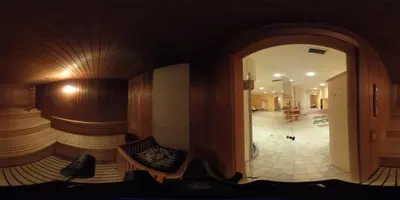 a room with a large mirror and a room with a hallway at Hotel Stella Montis in Campitello di Fassa