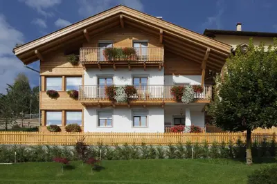 a house with balconies and flowers on it at Villa Prafiorì in Cavalese