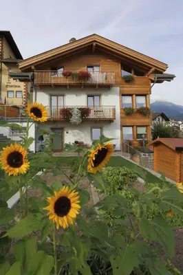 a house with sunflowers in front of it at Villa Prafiorì in Cavalese