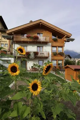 a house with sunflowers in front of it at Villa Prafiorì in Cavalese