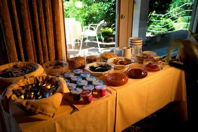 a table with food and jars of food on it at Hotel Tannerhof in Merano