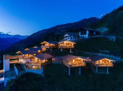 an aerial view of a house in the mountains at night at Mountain Village Hasenegg in Schenna
