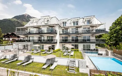 a hotel with a swimming pool and a resort at AMELIA rooms in Tirolo