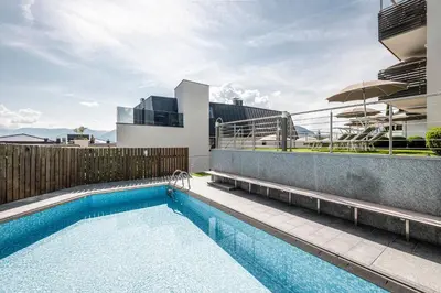 a swimming pool on the side of a building at AMELIA rooms in Tirolo