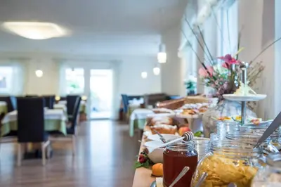 a table with food on it in a room at AMELIA rooms in Tirolo
