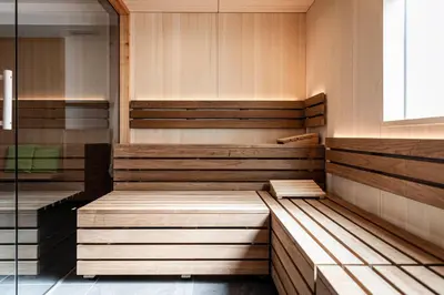 a sauna with wooden benches in a room at AMELIA apartments in Tirolo