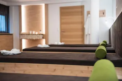 a room with two beds and a mirror at AMELIA apartments in Tirolo