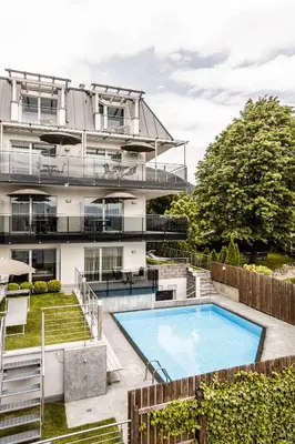 an image of a building with a swimming pool at AMELIA apartments in Tirolo