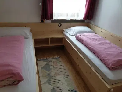 two bunk beds in a room with a window at Residence Alpenblick in Valles