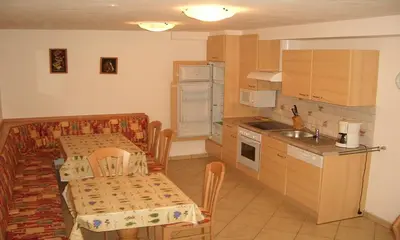 a kitchen with a table and a dining room at Residence Alpenblick in Valles