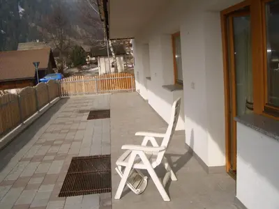 a white chair sitting on the side of a balcony at Residence Alpenblick in Valles