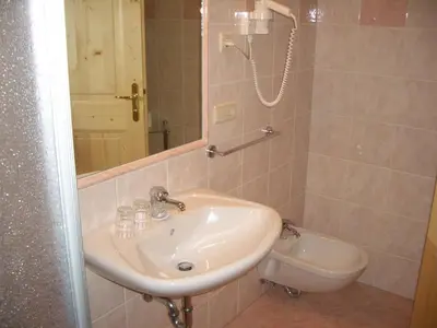 a bathroom with a sink and a shower with a mirror at Residence Alpenblick in Valles