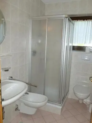 a bathroom with a shower and a toilet and a sink at Residence Alpenblick in Valles