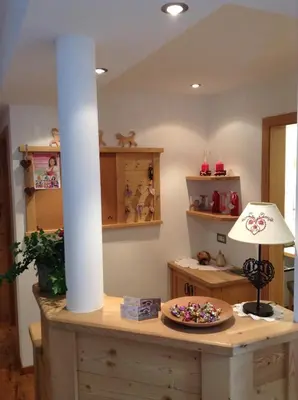 a room with a table with a white pillar and a plate at Villa Seceda in Selva di Val Gardena