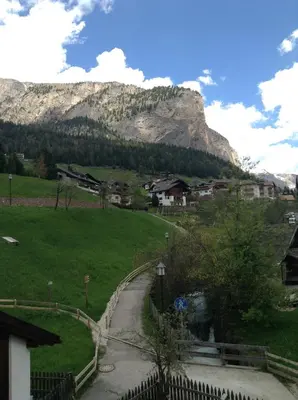 a winding road in a village with a mountain at Villa Seceda in Selva di Val Gardena