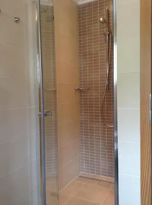 a shower stall with a glass door in a bathroom at Villa Seceda in Selva di Val Gardena