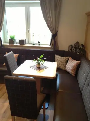 a living room with a table and a couch at Villa Seceda in Selva di Val Gardena