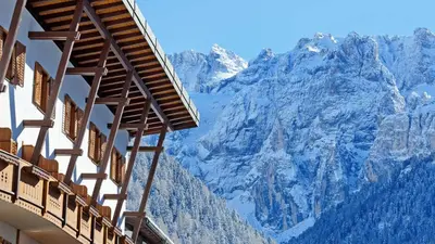 a view of the mountains from a building at Hotel Des Alpes in Selva di Val Gardena