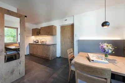 a kitchen and dining room with a table and chairs at Hörmannhof in Bressanone