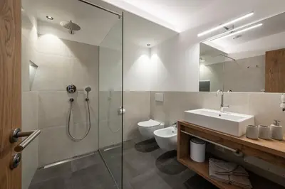 a bathroom with a shower and a sink and a toilet at Hörmannhof in Bressanone