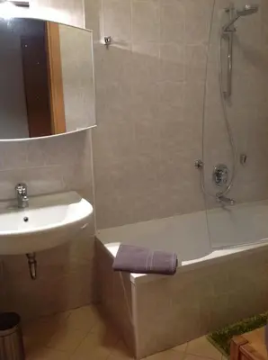 a bathroom with a tub and a sink and a shower at HOME DI CRISTINA in Laives