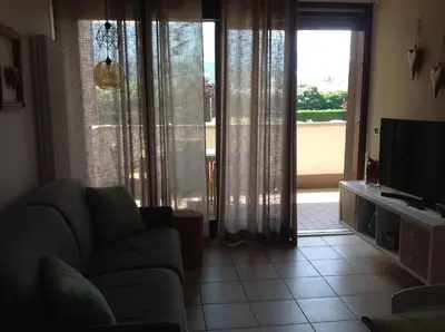 a living room with a couch and a television at HOME DI CRISTINA in Laives