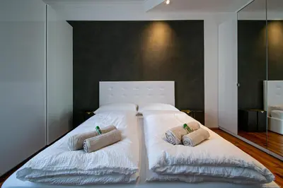 a large white bed with two pillows on it at Apartment Andreas in Bolzano