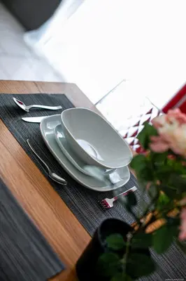 a table with a bowl and plates on a table at Apartment Andreas in Bolzano