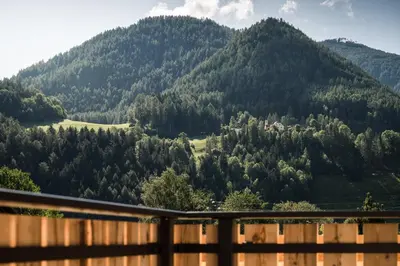 a view from the deck of a house with a mountain at Chalet Dolomit in San Lorenzo di Sebato