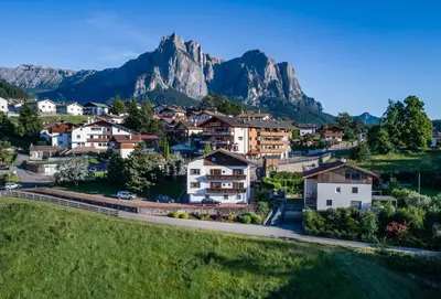 a small town in the mountains with houses at Apartments Sayonara in Castelrotto
